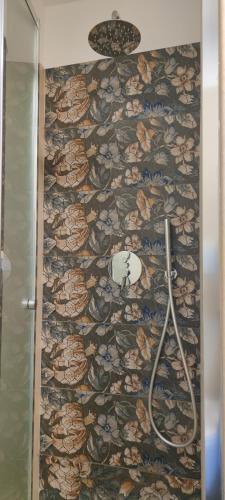 a bathroom with a stone wall and a shower at Antica Dimora Vada' in Alberobello