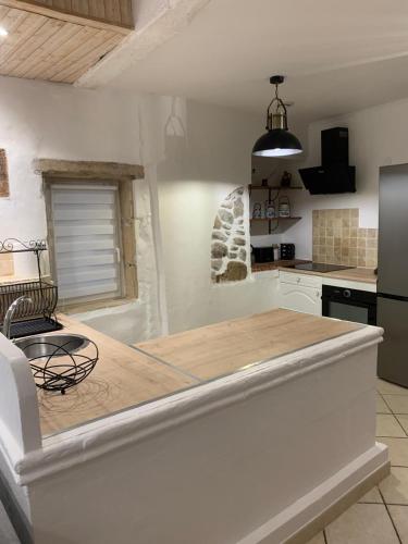 une cuisine avec un comptoir en bois dans une pièce dans l'établissement Maison calme - Rue piétonne - Ardeche - ViaRhona - Dolce Via, à La Voulte-sur-Rhône