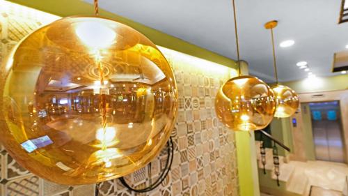 a couple of lights hanging from a wall at Hotel Ajanta - Colonial Charm Award Winning Luxury Hotel in the Heart of the City in New Delhi