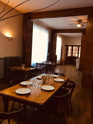 a large wooden table in a room with tables and chairs at Le Lion d'Or chb 4 pers wifi 11 in Écueillé