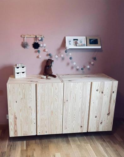 a wooden cabinet with a stuffed bear sitting on top of it at Villa Skogsfred in Svartå