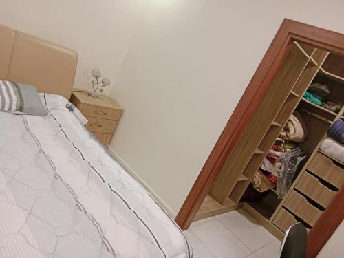 a bedroom with a bed and a dresser with a closet at شقة جميلة in Irbid