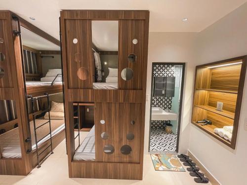 a room with a wooden closet with a mirror at Chi's House Cao Bang in Hoàng Ngà