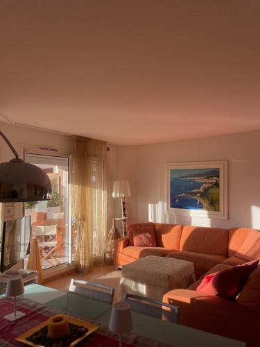 a living room with a couch and a table at Beautiful apartment very close to the sea in Roquebrune-Cap-Martin