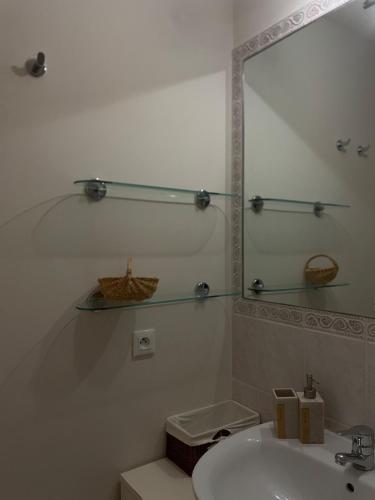 a white bathroom with a sink and a mirror at Beautiful apartment very close to the sea in Roquebrune-Cap-Martin
