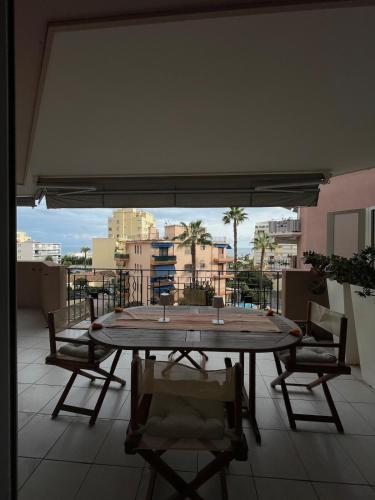 a table on a balcony with a view of a city at Beautiful apartment very close to the sea in Roquebrune-Cap-Martin