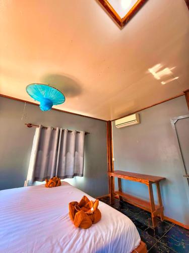 a bedroom with two teddy bears laying on a bed at Kohrong Central Beach in Koh Rong Island