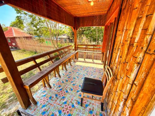 a porch with a bench and a table at Kohrong Central Beach in Koh Rong Island