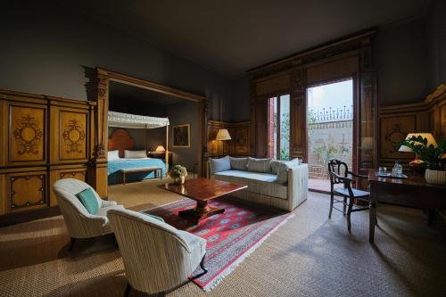 a living room with a bed and a room with a table at Can Cera Hotel in Palma de Mallorca