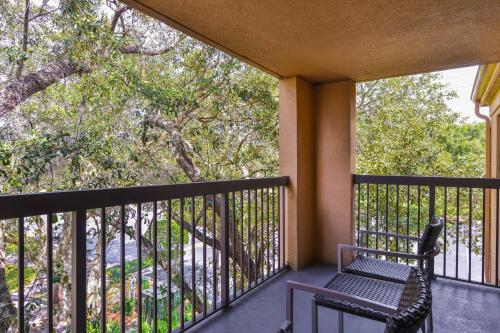 a balcony with a bench and a tree at Courtyard Tampa North / I-75 Fletcher in Tampa