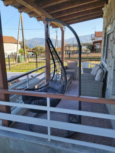 a swing on the porch of a house at Apartment sofia sea view in Vrasná
