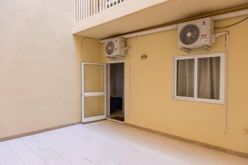 a building with an open door and a fan at Your quiet retreat in Marsalforn in Marsalforn