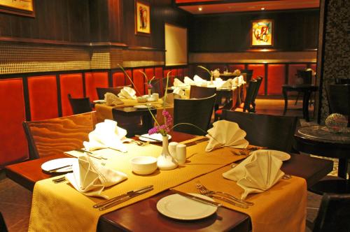 a dining room with a table with yellow table cloth at فندق أميري سويت in Umm Uthainah