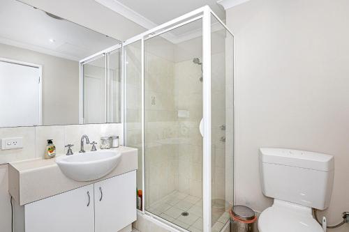a bathroom with a shower and a toilet and a sink at Pause & Play A Sepal Stay in Perth