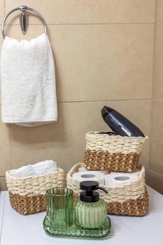 a bathroom counter with two baskets and a hair dryer at Sea View Villa Emmanuela, By IdealStay Experience in Paránimfoi
