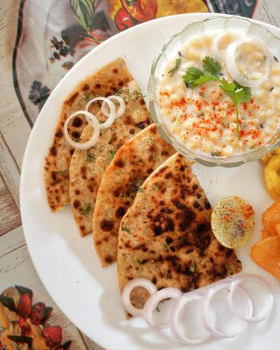 a white plate of food with dip and tortillas at Tinton Hillstay in Chikmagalūr