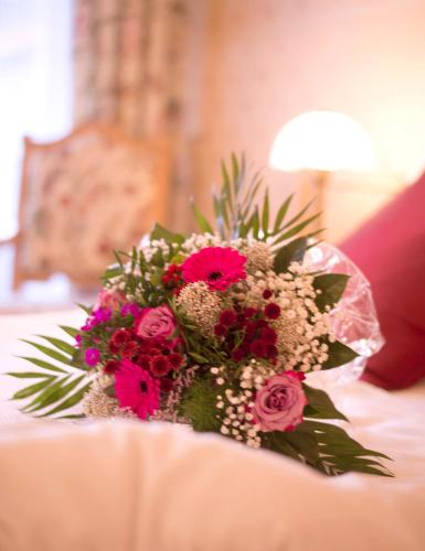 a bouquet of flowers sitting on top of a table at Hotel Heikenberg in Bad Lauterberg