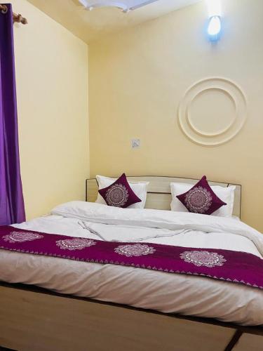 a bedroom with a large bed with purple pillows at The Hidden Cove in Bhīm Tāl