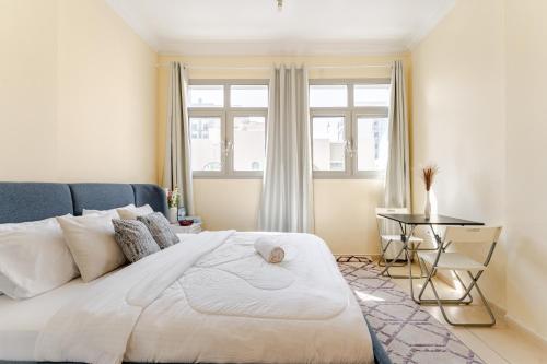 a bedroom with a large bed and a table at Jannath home in Abu Dhabi