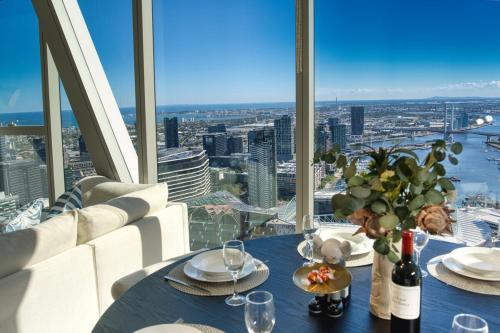 a dining table with a view of a city at Park Avenue Melbourne in Melbourne