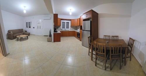 a kitchen and living room with a table and chairs at Giannis's Apartments in Chios
