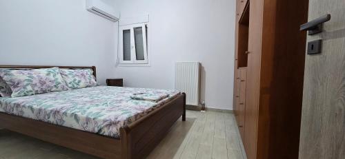a bedroom with a bed and a window at Giannis's Apartments in Chios