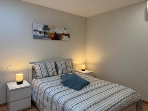 a bedroom with a bed with two night stands and two lamps at Casinhas Dom Afonso by Hotel Dom Afonso in Monção