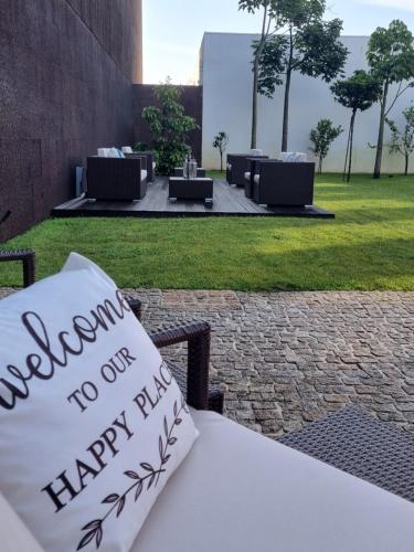 a pillow sitting on a bench with aulum happy birthday at DS Hotel Lusopark in Santa Maria da Feira