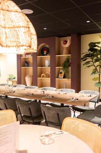 a dining room with tables and chairs and shelves at ibis Lille Centre Gares in Lille