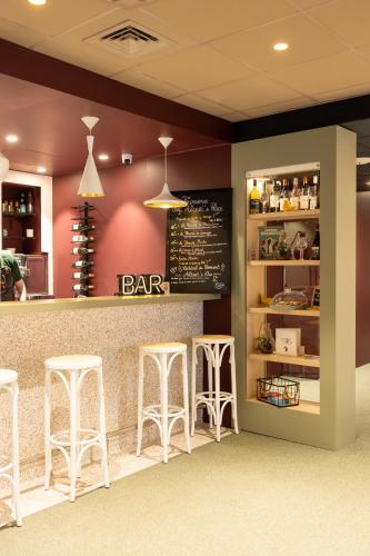 a bar in a restaurant with stools at ibis Lille Centre Gares in Lille