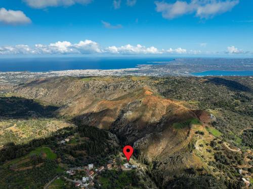 a red marker on top of a mountain at Achlades The Mountain Paradise Villas - Studio with pool! in Aletrouvárion