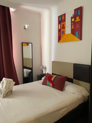 Ένα ή περισσότερα κρεβάτια σε δωμάτιο στο Hotel Plebiscito Aparthotel