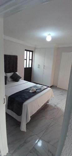 a bedroom with a large bed in a room at Falconbridge Properties in Krugersdorp