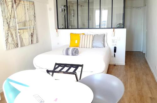 a living room with a couch and a table at Hotel La Marine, Vieux Port in La Rochelle
