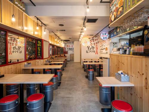 a row of tables and stools in a restaurant at APA Hotel Ueno Ekiminami in Tokyo