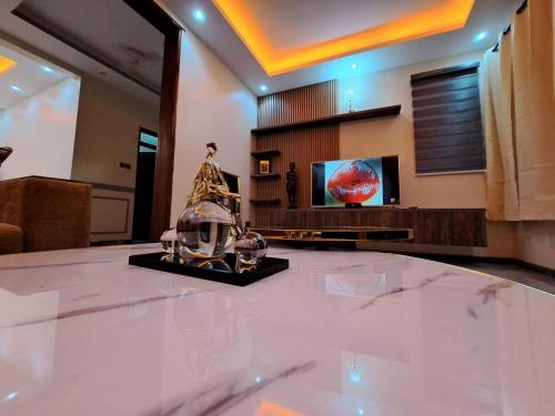 a living room with a large marble table with a television at Holiday Home via Entebbe in Nalugala
