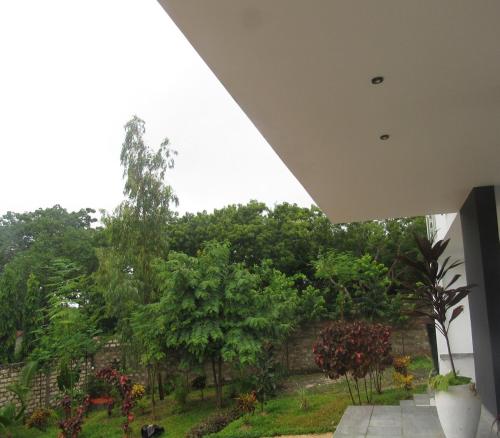 a view of a garden from a house at Breakfast Included at Pes Villa Diani Beach in Diani Beach