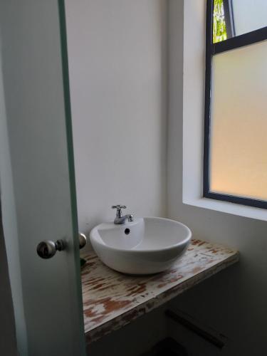 a bathroom with a white sink on a counter at Breakfast Included at Pes Villa Diani Beach in Diani Beach