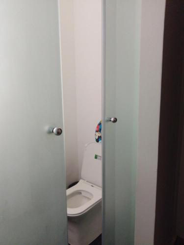 a bathroom with a white toilet in a room at Breakfast Included at Pes Villa Diani Beach in Diani Beach