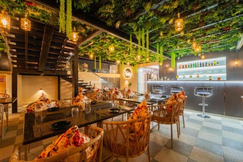 a restaurant with a long table and chairs and ceilings at Royal Prime - A City Center Boutique Hotel In Jaipur in Jaipur