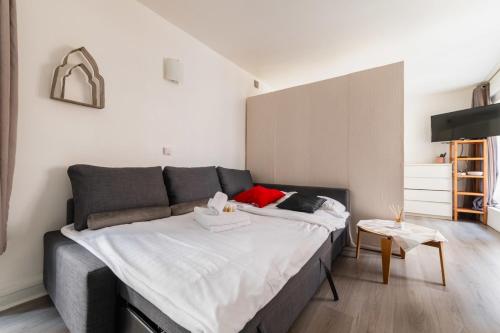 une chambre avec un grand lit et une table dans l'établissement Grand Studio fonctionnel Republique - Paris 10, à Paris