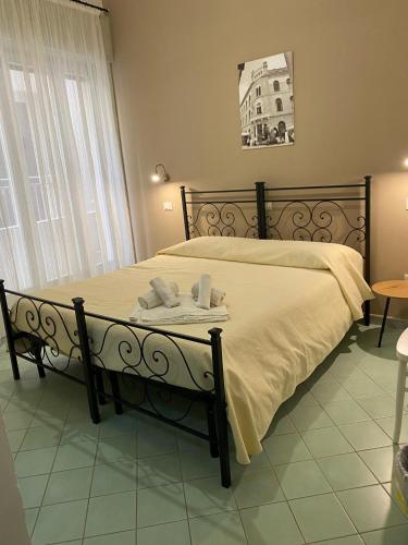 a bedroom with a bed with towels on it at Le 5 Torri in Trapani