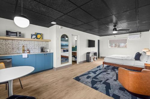 a bedroom with a bed and a table and a kitchen at Arka Motel in Rogers