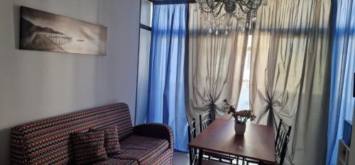 a living room with a couch and a table and a window at PACEVILLE St Julians Apartments in St Julian's