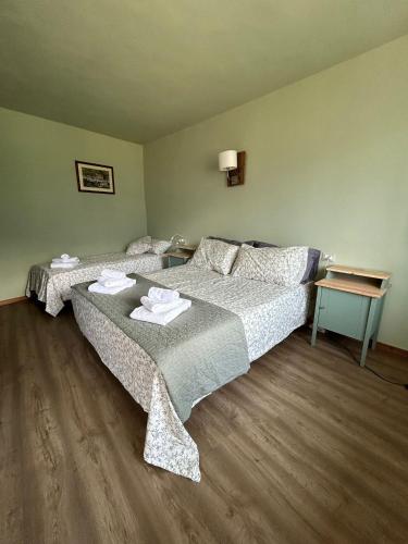 a bedroom with two beds with towels on them at Guest House nel Vigneto in Traona