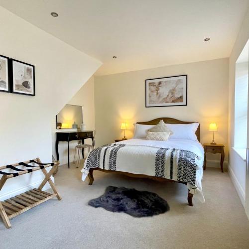 a bedroom with a bed and a desk in it at No 6 Bowling Green Yard in Knaresborough