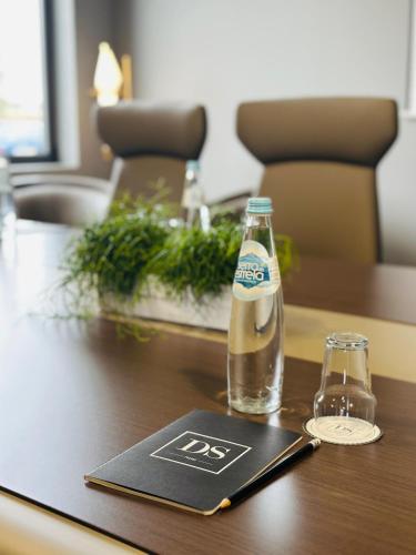 a bottle of beer and a glass on a table at DS Hotel Lusopark in Santa Maria da Feira