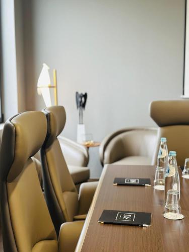 a conference room with a wooden table and chairs at DS Hotel Lusopark in Santa Maria da Feira
