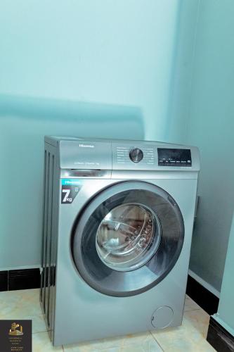 a washer and dryer in a room at Safa Homes and Residences in Kampala
