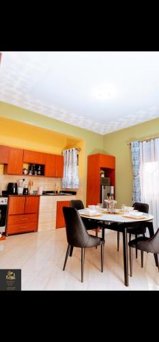 a kitchen with a table and chairs in a room at Safa Homes and Residences in Kampala